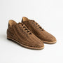 Pair of tobacco brown woven leather Huarache boots with tan laces on a white background.