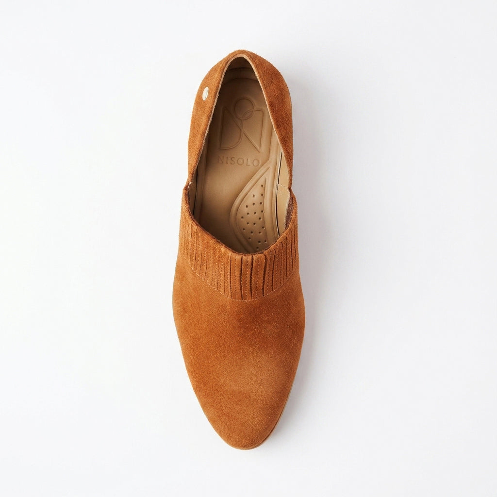 Single terracotta suede slip-on shoe with a pointed toe and NISOLO printed on the tan inner sole.